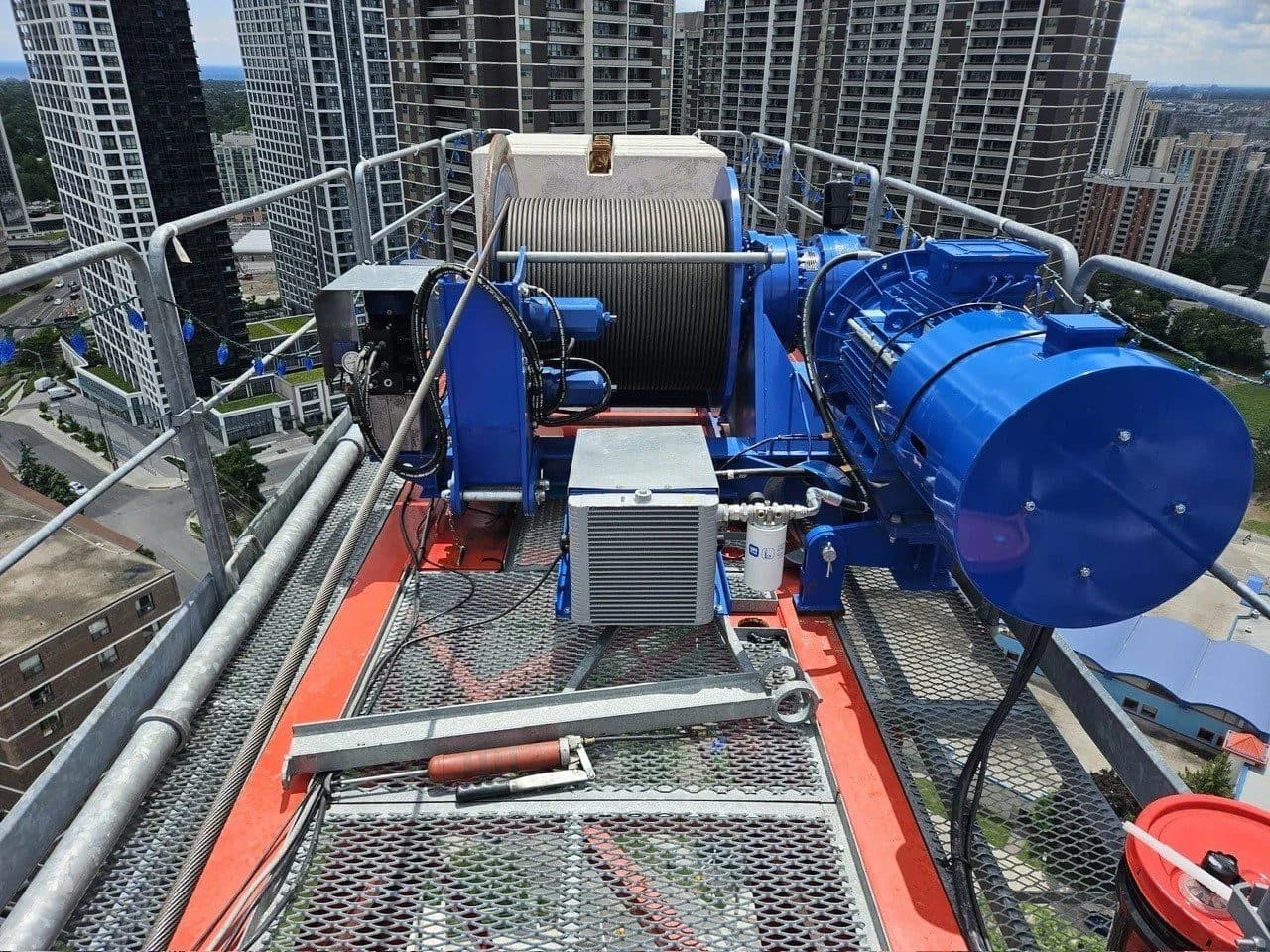 Hoist winch and motor on top of a tower crane above the Toronto skyline