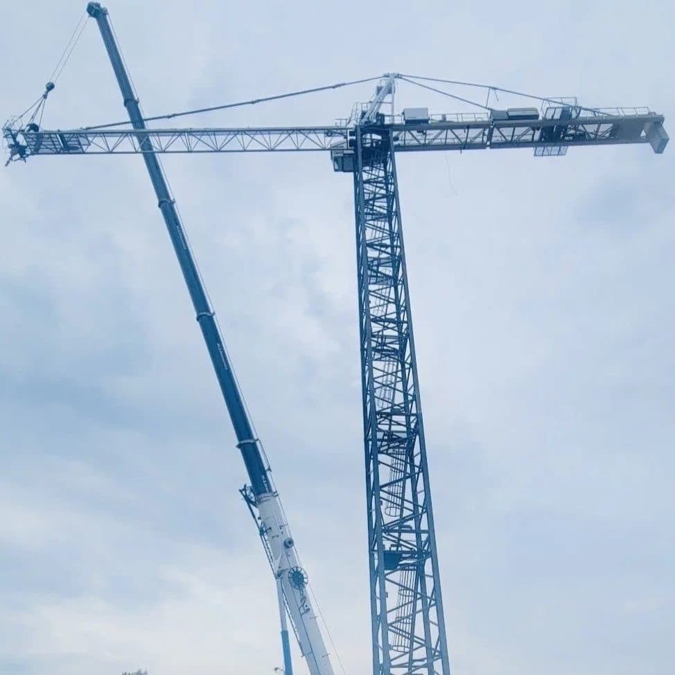 Tower crane being erected with a mobile crane